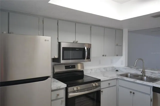 a kitchen with a sink and a stove top oven