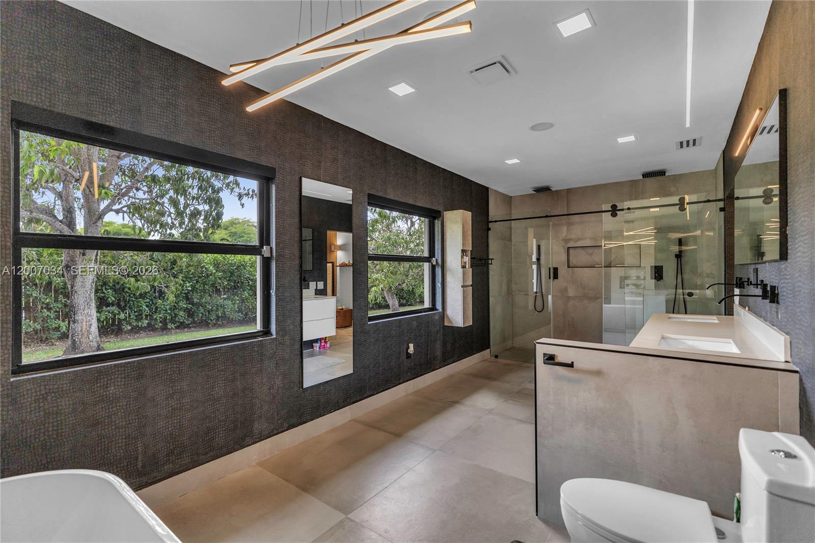 13540 Southwest 98th Court Miami, FL 33176 - Photo 12 of 43 a bathroom with a toilet sink and mirror