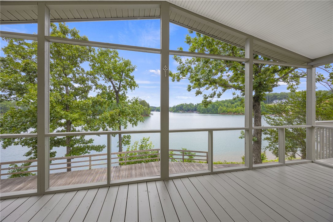 1230 Melton Road, Unit 30 West Union, SC 29696 - Photo 3 of 42 A spacious screened porch overlooks a tranquil lake, offering breathtaking water views.