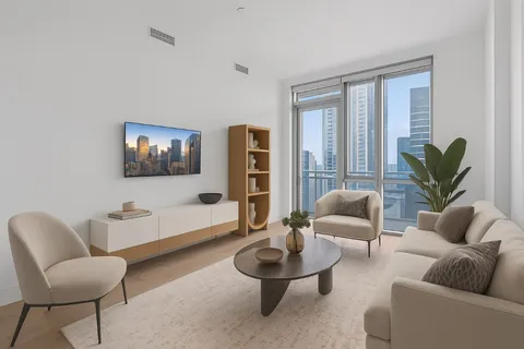 a living room with furniture and a potted plant
