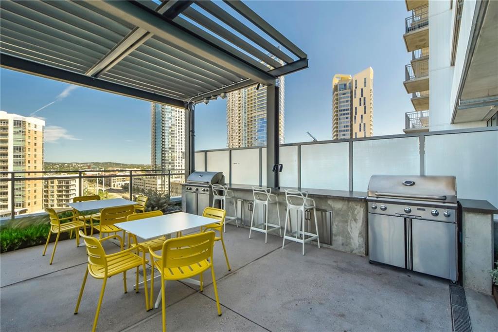 222 West Avenue, Unit 2109 Austin, TX 78701 - Photo 14 of 20 View of patio featuring a city view, exterior kitchen, outdoor dining area, and a grill