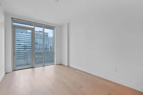 a view of an empty room with glass door