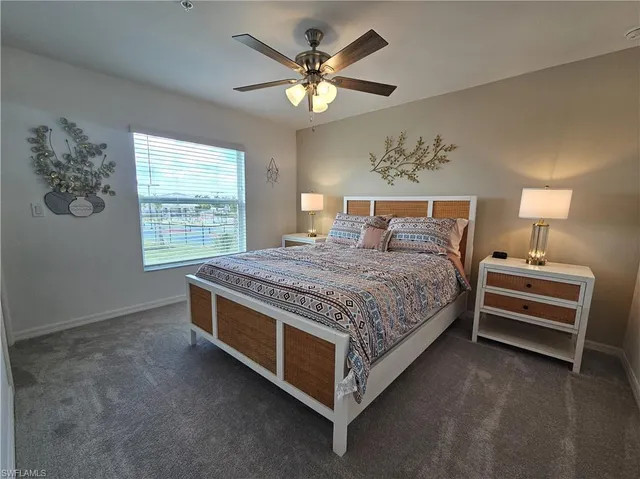 a spacious bedroom with a bed and a lamp