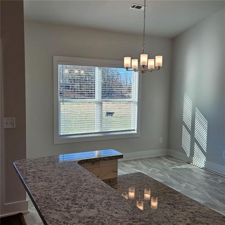201 Damascus Road Homer, GA 30547 - Photo 13 of 37 a kitchen area with granite countertop a stove a sink and a window