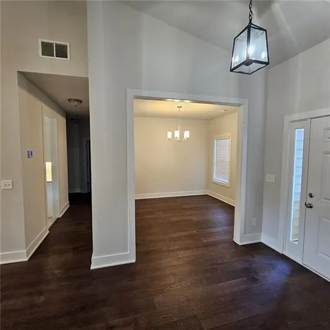 a view of a room with wooden floor