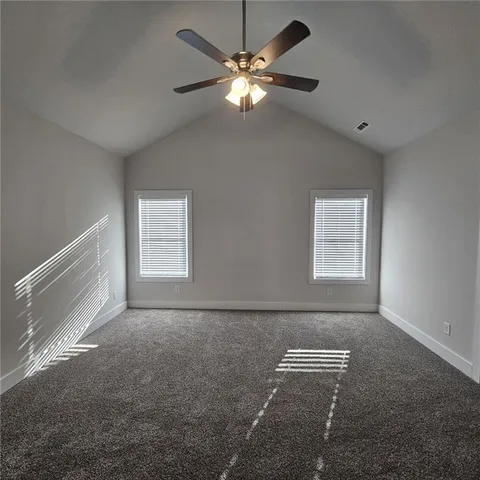 a view of room with window and ceiling fan