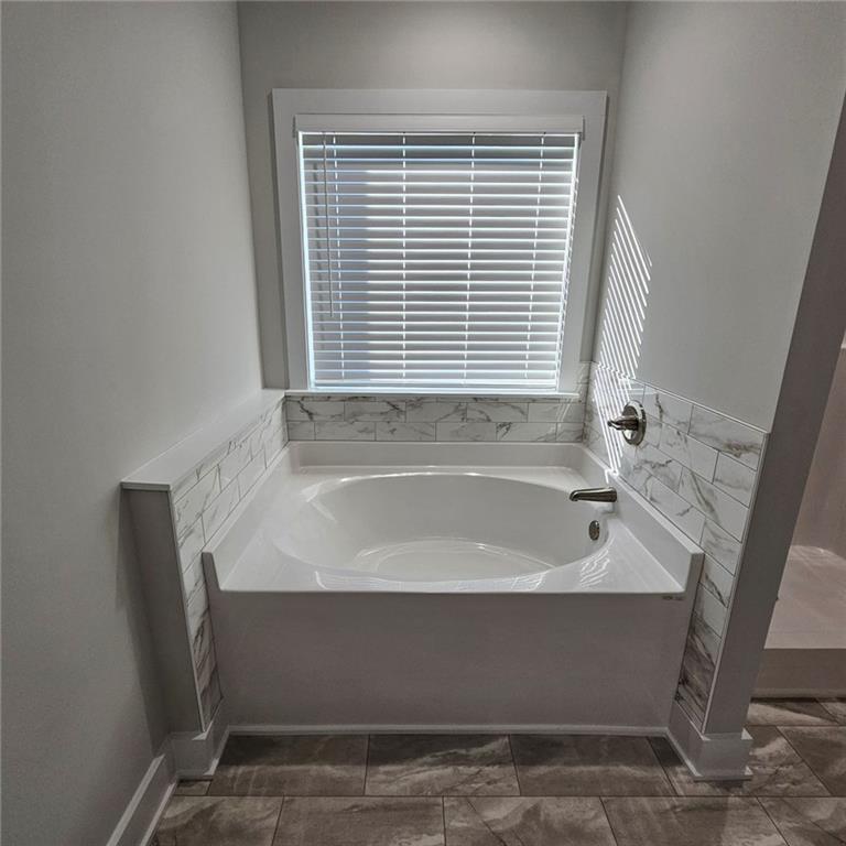 201 Damascus Road Homer, GA 30547 - Photo 26 of 37 a bathroom with a bathtub and next to a window