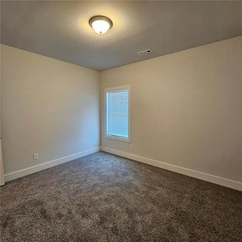 an empty room with a empty space and a window