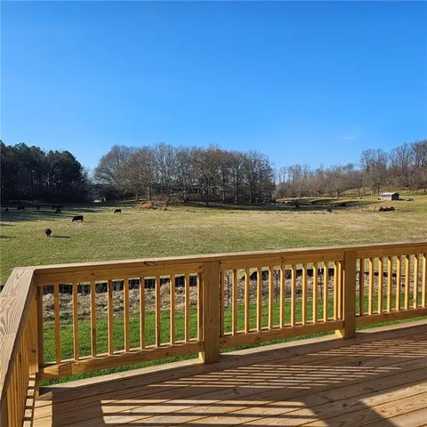 a view of a green field with lake view