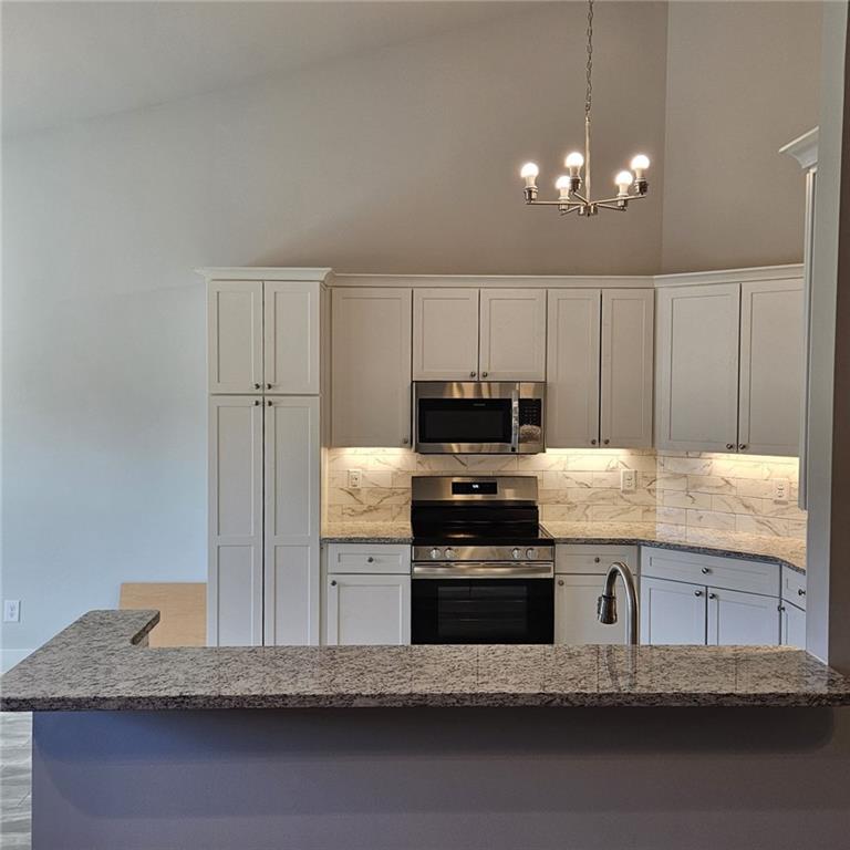 201 Damascus Road Homer, GA 30547 - Photo 9 of 37 a kitchen with granite countertop a stove a sink and a refrigerator