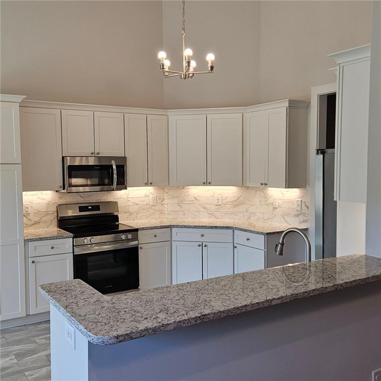 201 Damascus Road Homer, GA 30547 - Photo 10 of 37 a kitchen with granite countertop a sink and a stove