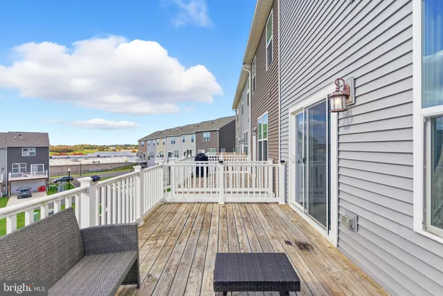 a view of a balcony with wooden floor and fence