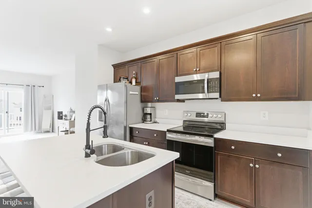 a kitchen with a sink cabinets and appliances