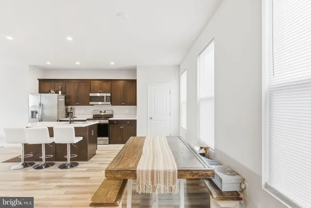 a large white kitchen with a large window