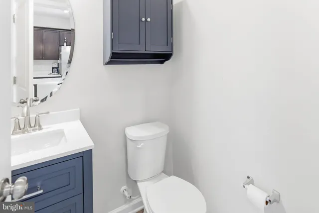 a white toilet sitting next to a bathroom sink