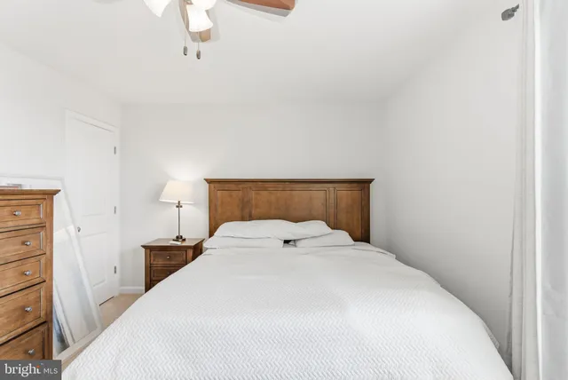 a bedroom with a bed and a painting on the wall