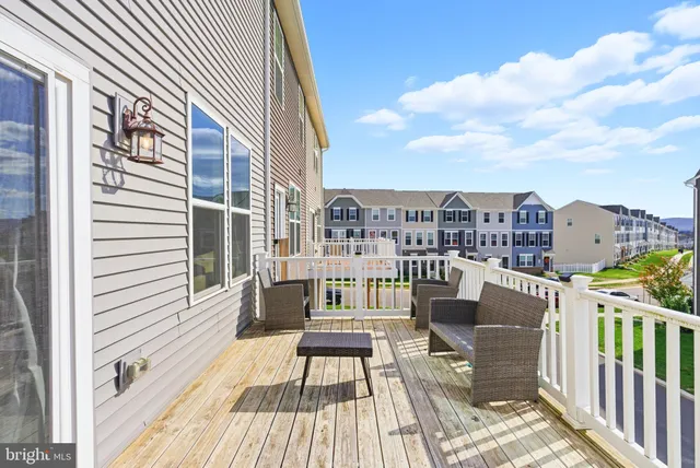 a view of a balcony with two chairs and a potted plant