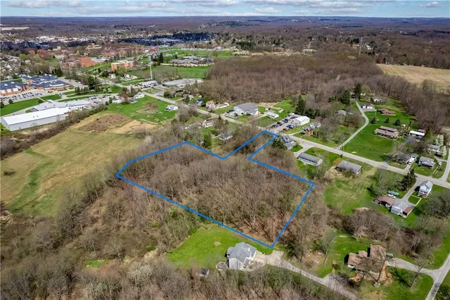 an aerial view of a houses with a yard