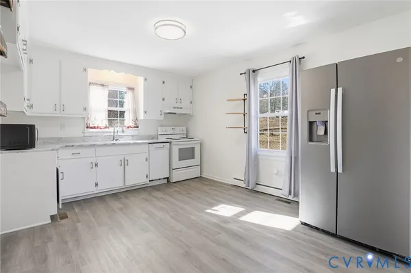 a kitchen with stainless steel appliances a refrigerator sink and cabinets