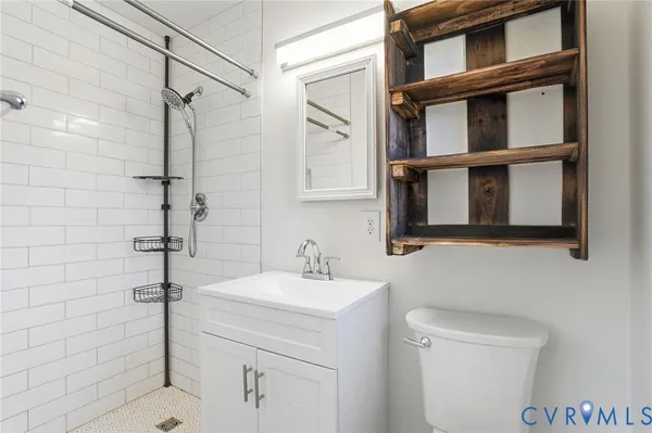 a bathroom with a sink toilet and shower