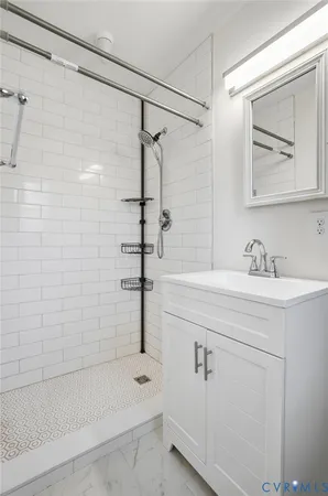 a bathroom with a shower sink and mirror