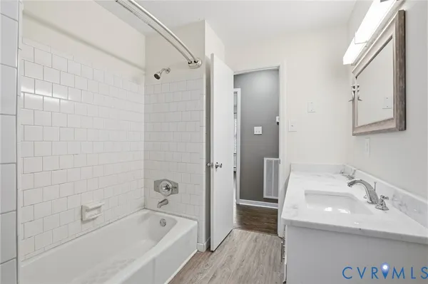 a bathroom with a bathtub and a sink