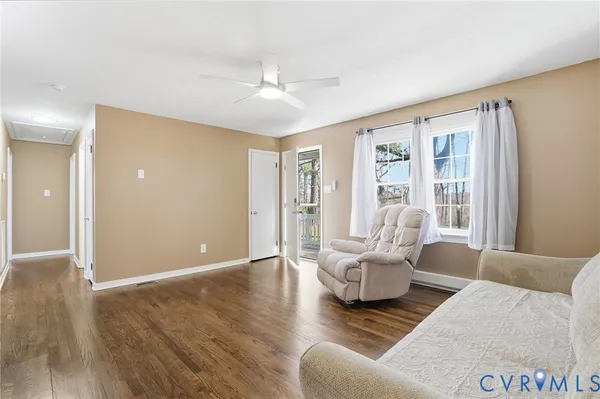 a living room with furniture and wooden floor