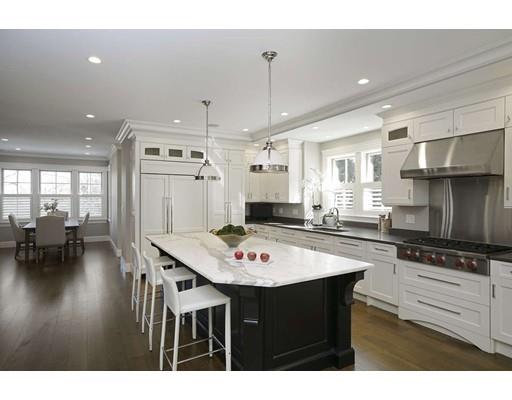 20 Gammons Road Newton, MA 02468 - Photo 13 of 28 a kitchen with a dining table chairs and white cabinets