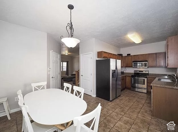 13548 South Villa Rosa Way Draper, UT 84020 - Photo 7 of 28 Kitchen featuring stainless steel appliances, wood-finish cabinetry, and tiled flooring