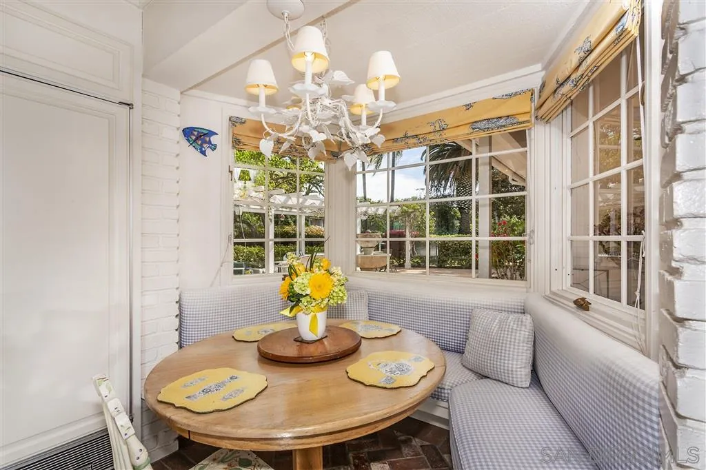 8317 La Jolla Shores Drive La Jolla, CA 92037 - Photo 13 of 25 a view of a dining room with furniture a chandelier and wooden floor