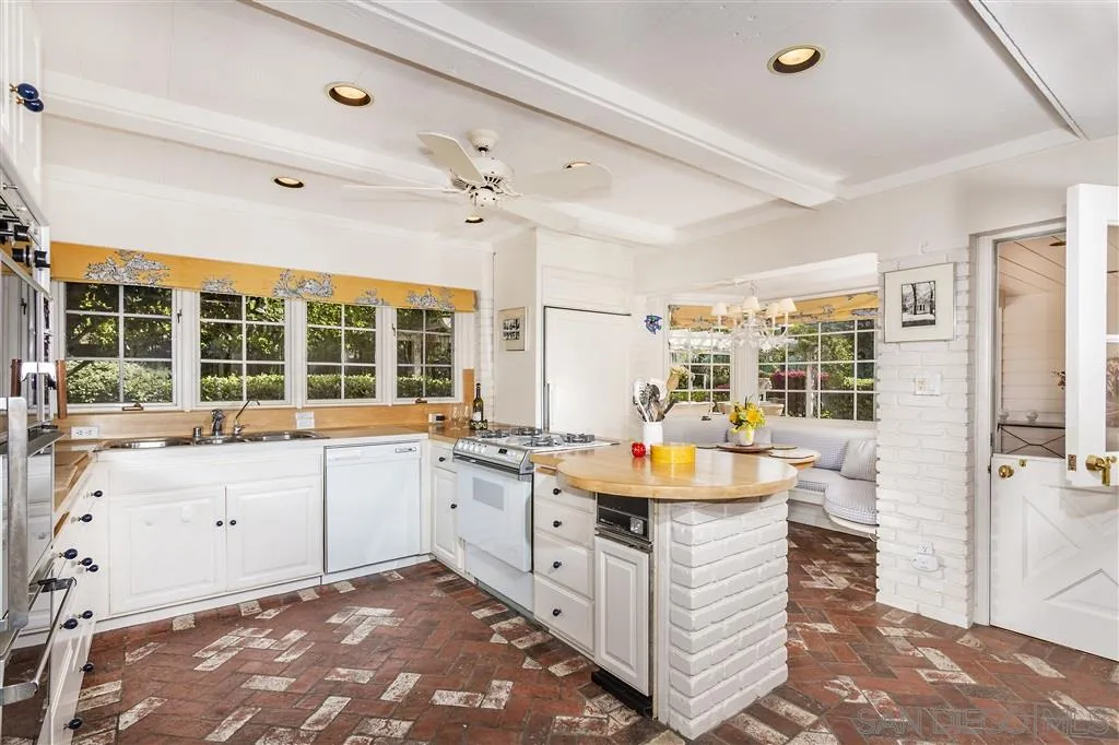 8317 La Jolla Shores Drive La Jolla, CA 92037 - Photo 14 of 25 a large white kitchen with a large window