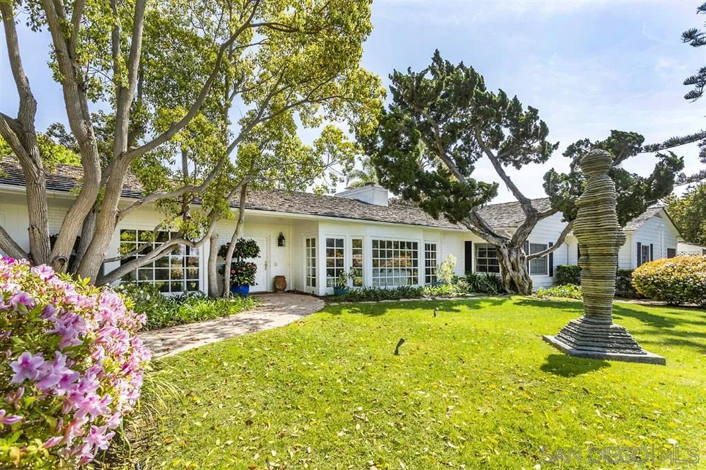 8317 La Jolla Shores Drive La Jolla, CA 92037 - Photo 22 of 25 a front view of a house with a yard table and chairs