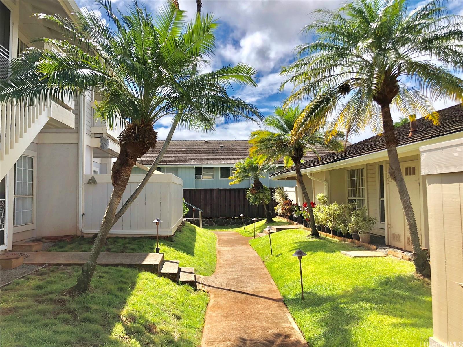 a view of a house with swimming pool and sitting area