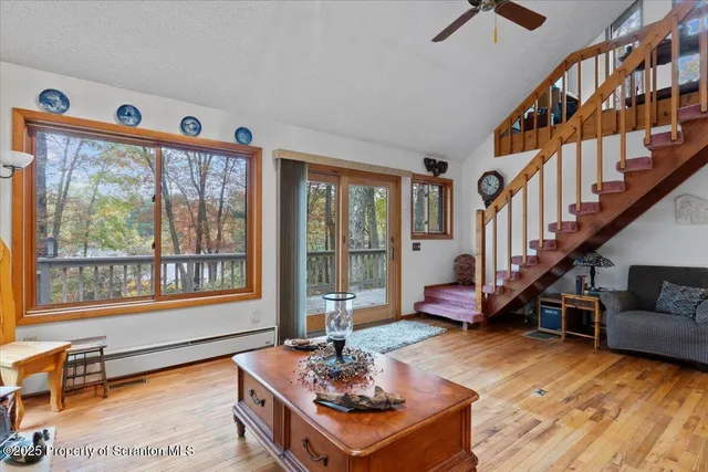 a living room with furniture and a floor to ceiling window