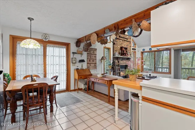 a very nice looking dining room with a large window and dining table