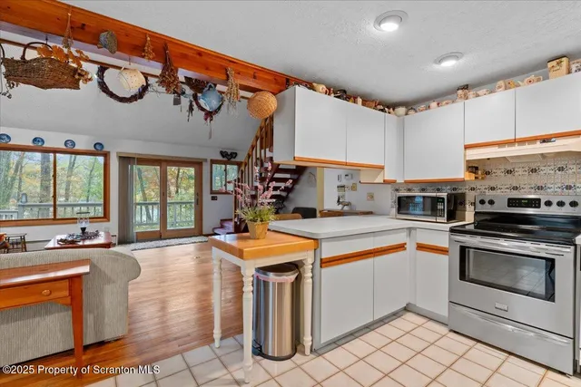a kitchen with stainless steel appliances granite countertop a sink and cabinets