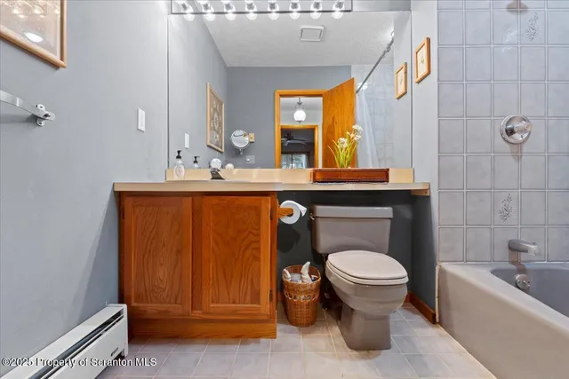 a bathroom with a sink a toilet and bathtub