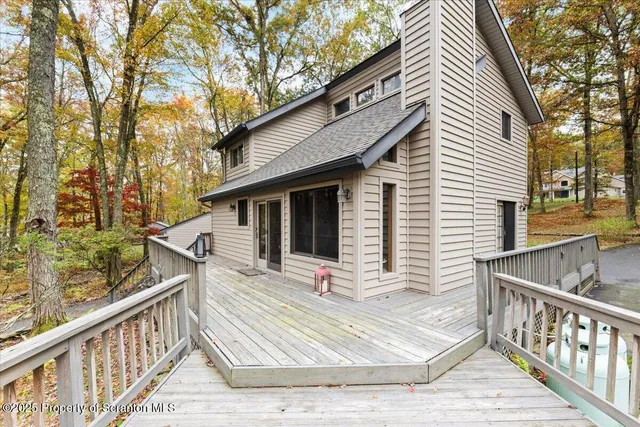 a view of wooden house with a wooden fence