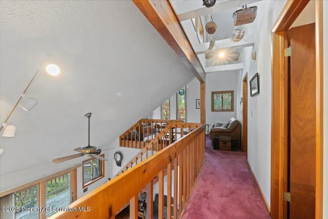 a view of an entryway wooden floor and windows