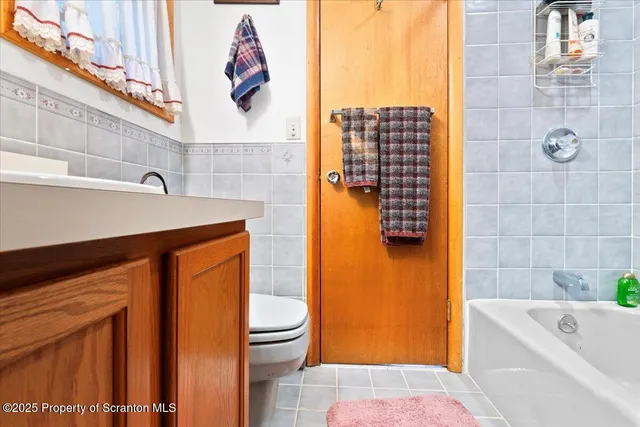 a bathroom with a bathtub sink and toilet