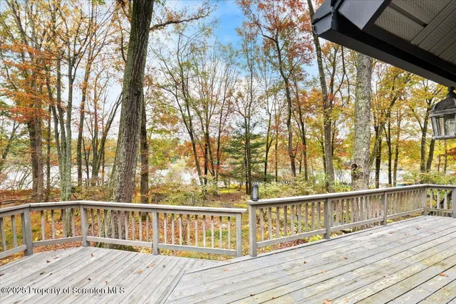 a view of balcony with wooden floor and fence