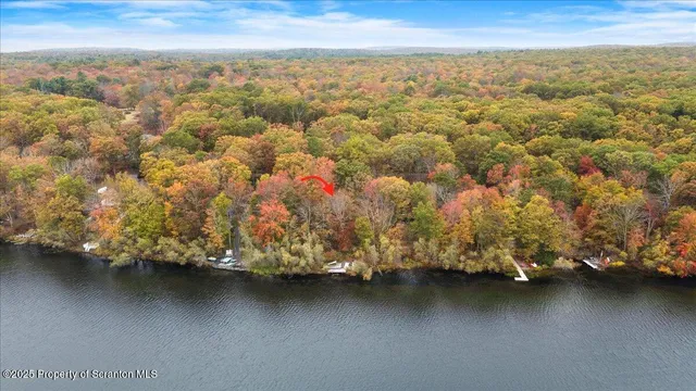 an aerial view of residential houses with outdoor space and swimming pool