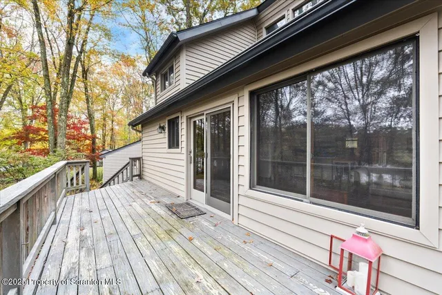 a view of balcony with floor to ceiling window and wooden floor