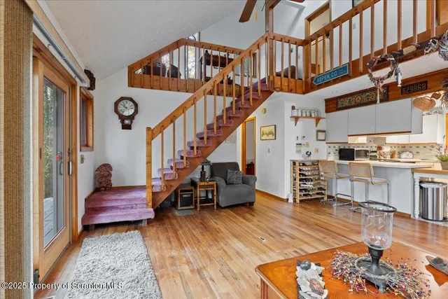 a view of entryway and hall with wooden floor