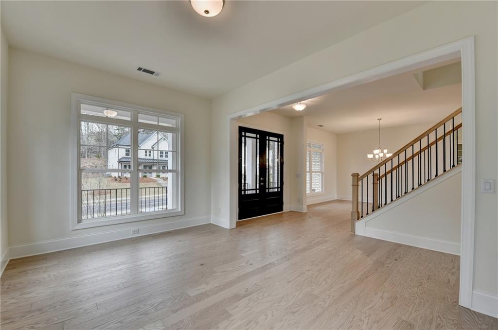 2470 Stewart Road Cumming, GA 30041 - Photo 11 of 61 an empty room with wooden floor and windows