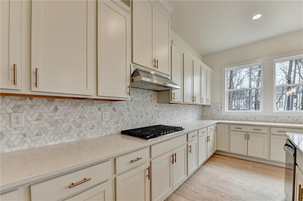 2470 Stewart Road Cumming, GA 30041 - Photo 22 of 61 a kitchen with granite countertop white cabinets and white appliances