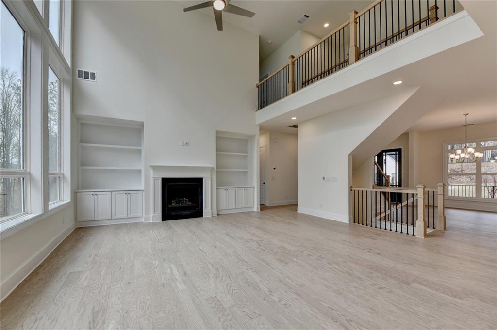 2470 Stewart Road Cumming, GA 30041 - Photo 24 of 61 an empty room with windows and fireplace