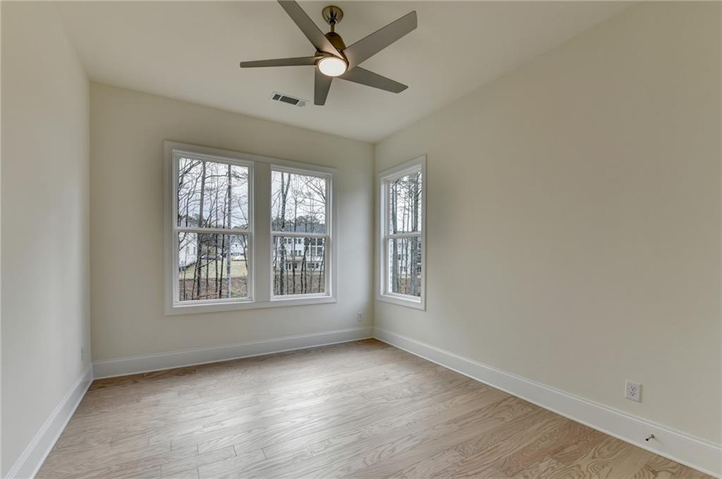 2470 Stewart Road Cumming, GA 30041 - Photo 28 of 61 an empty room with chandelier fan and windows