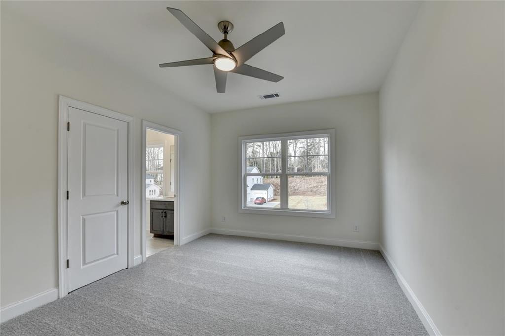 2470 Stewart Road Cumming, GA 30041 - Photo 38 of 61 an empty room with windows and fan