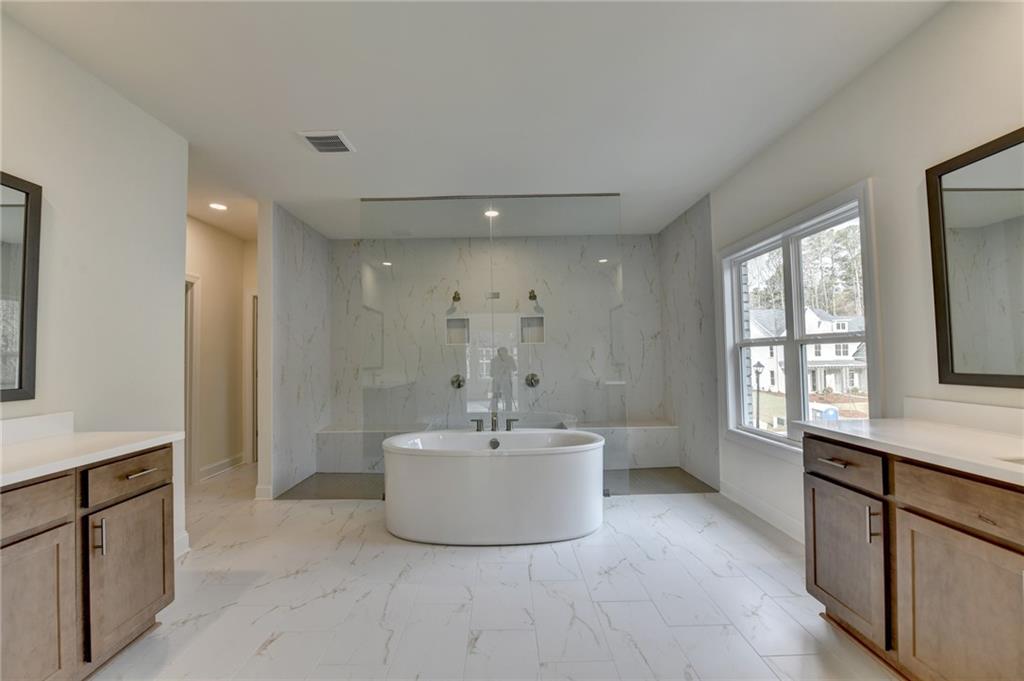 2470 Stewart Road Cumming, GA 30041 - Photo 46 of 61 a bathroom with a sink a bathtub and a window